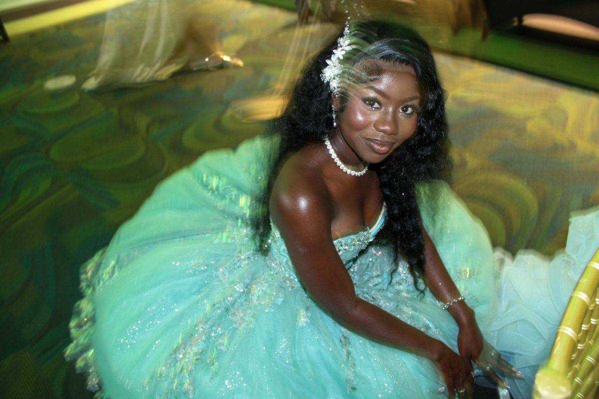 Senior Ndey Barrow helping her friend put on heels at prom.  Prom was held at USF on Friday, April 25.